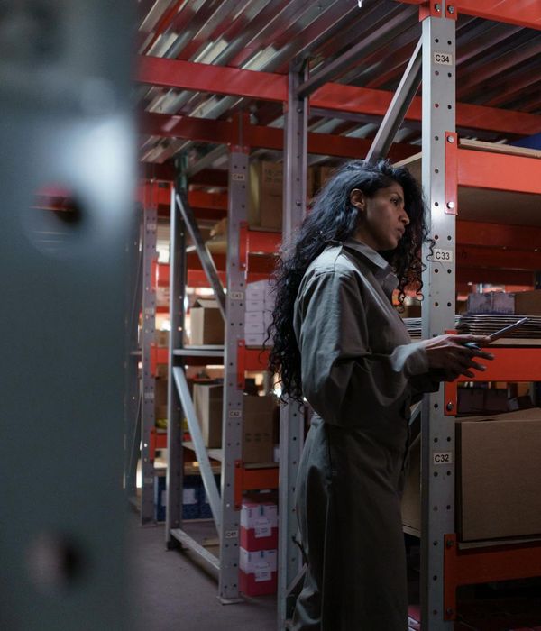 Modern warehouse with organized inventory shelves and forklift operations