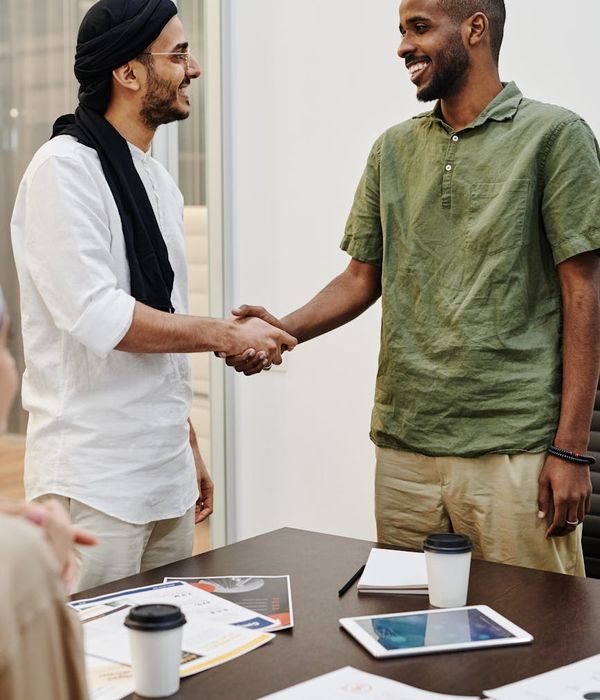 Two professionals collaborating and supporting each other